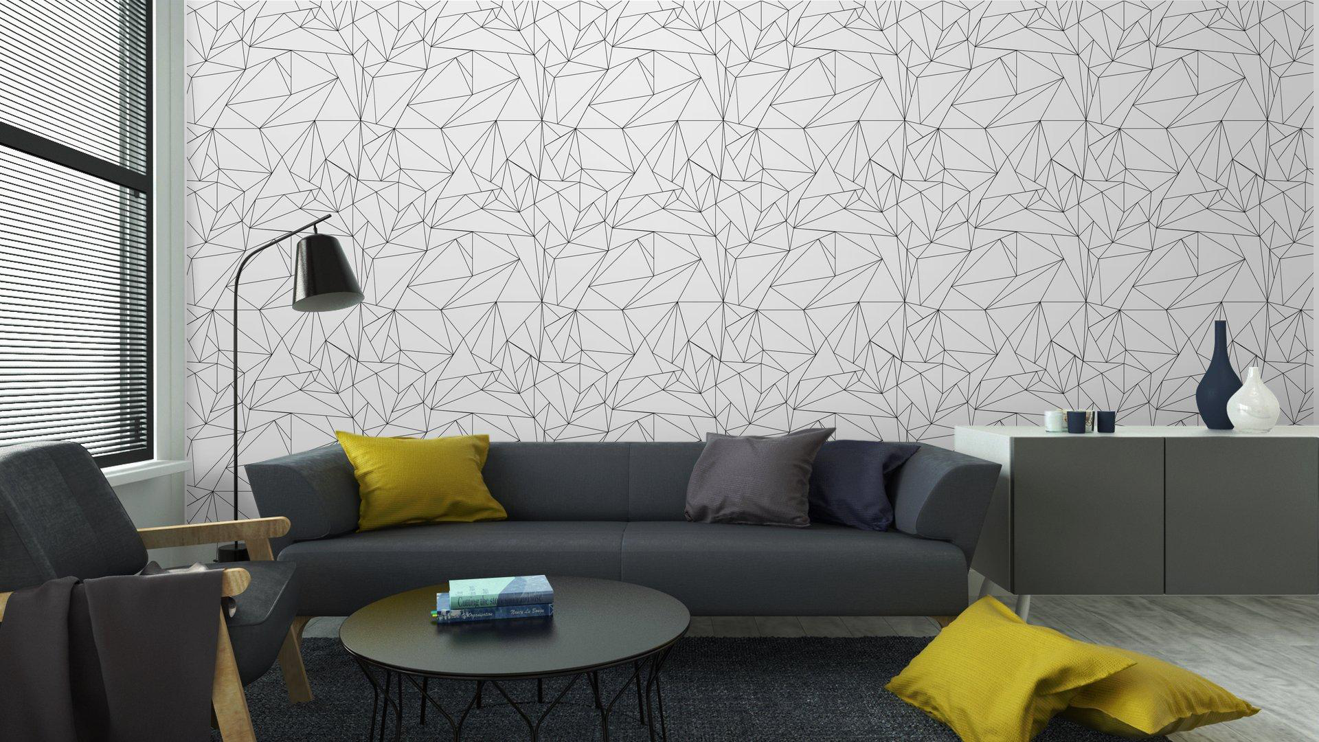 Sala elegante con tapiz geométrico destacado en la pared y decoración moderna.